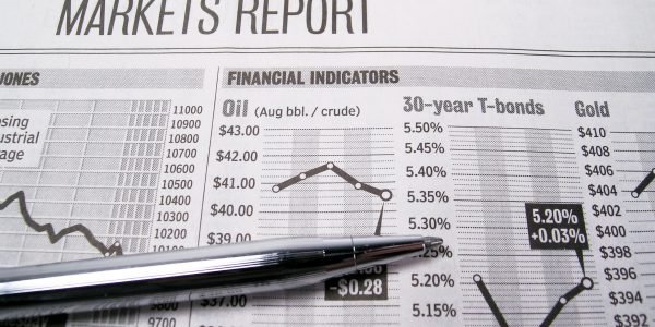 Stock market page of newspaper with pen Pen on the Market section of a newspaper.
